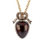 A late Victorian garnet and diamond memorial pendant. The heart-shape garnet cabochon front, with
