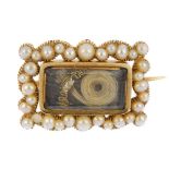 A mid 19th century 12ct gold split pearl memorial brooch. The rectangular arranged hair panel,