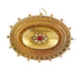 A late 19th century 9ct gold synthetic ruby and split pearl memorial brooch. Of oval outline, the