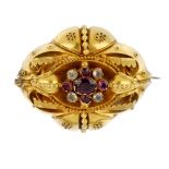 A late 19th century gold gem-set memorial brooch. The oval and circular-shape garnet and