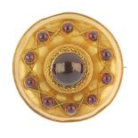 A late Victorian 18ct gold and garnet memorial brooch. Of circular outline, the circular garnet