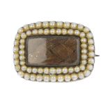 A late 19th century gold split pearl memorial brooch. Of cushion-shape outline, the woven hair