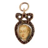 An early 19th century garnet miniature portrait pendant. The pear-shape hand painted portrait,