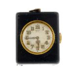 A quarter repeater travel clock by Cartier. Black leatherette case. Numbered 124357. Manual wind