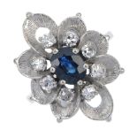 An 18ct gold sapphire and diamond cluster ring. Of floral design, the oval-shape sapphire, within