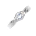 A platinum diamond single-stone ring. The brilliant-cut diamond, to the crossover shoulders and