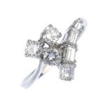 A diamond dress ring. The brilliant-cut diamond trefoil, to the baguette-cut diamond line and