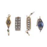 Four early to mid 20th century necklace clasps and a safety chain. To include a sapphire cabochon
