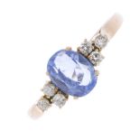 A sapphire and diamond ring. The oval-shape sapphire, between brilliant-cut diamond trefoil sides to