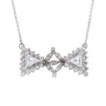 A diamond pendant. Designed as a stylised bow, the single-cut diamond geometric centre, to the