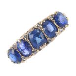 A mid 20th century gold sapphire, synthetic sapphire and diamond dress ring. The central oval-