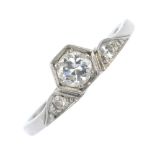 A diamond single-stone ring. The brilliant-cut diamond, within a hexagonal mount, off-set to the