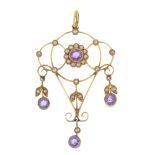 An early 20th century 9ct gold amethyst and split pearl pendant. Of openwork design, the circular-