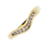 An 18ct gold diamond shaped-band ring. The brilliant-cut diamond chevron, to the plain band.