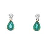 * A pair of emerald and diamond ear studs. Each designed as a pear-shape emerald, suspended from a