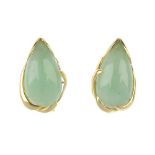 A pair of jade earrings. Each designed as a pear-shape nephrite jade cabochon, within a scrolling