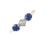 An early 20th century 9ct gold diamond and sapphire three-stone ring. The old-cut diamond, with