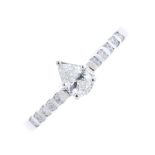 A diamond single-stone ring. The pear-shape diamond, to the brilliant-cut diamond line sides and