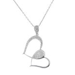 An 18ct gold diamond heart pendant. The scrolling heart, with brilliant-cut diamond chevron inset,