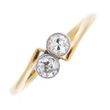 A mid 20th century 18ct gold diamond two-stone crossover ring. The circular-cut diamond line, to the