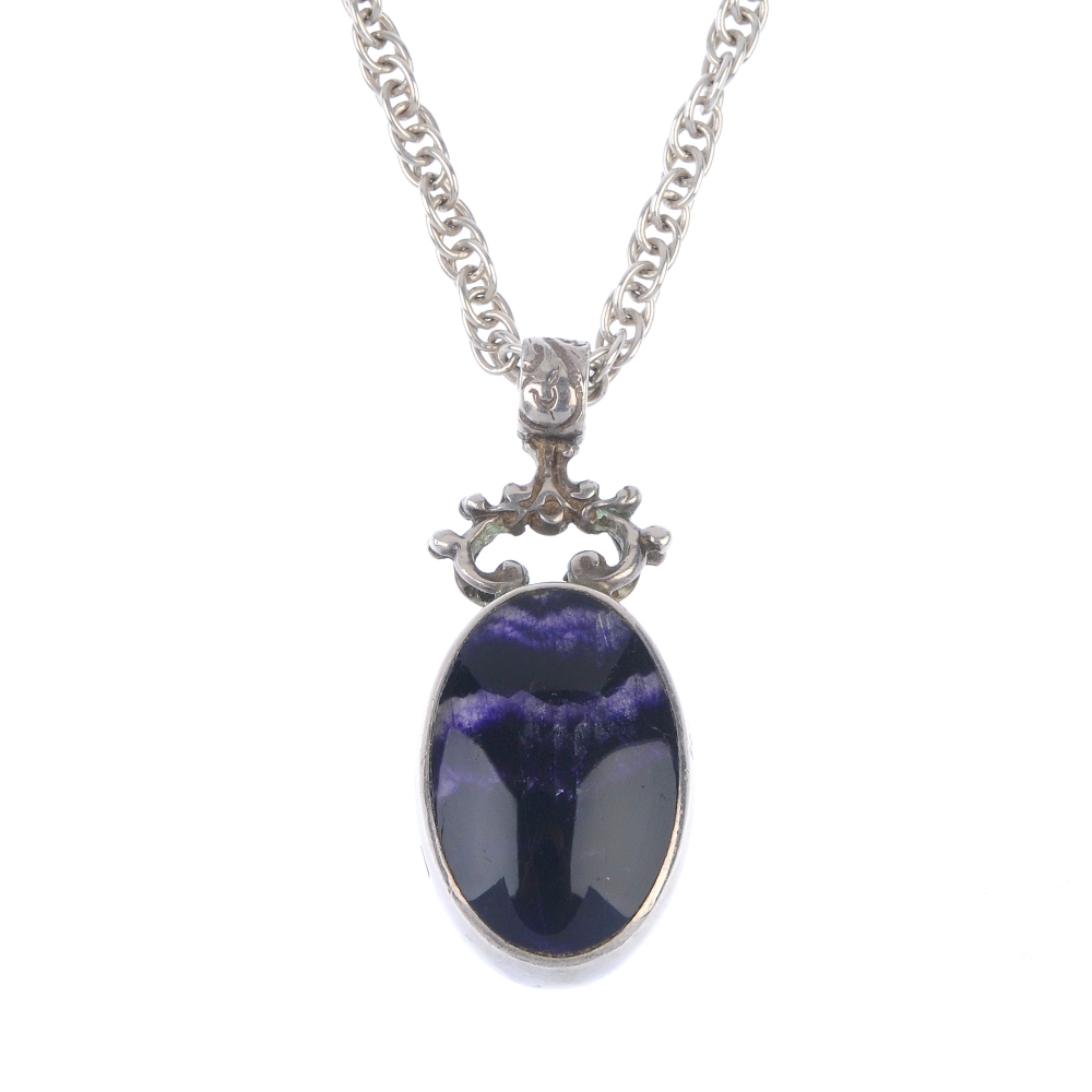 A Blue John pendant Of oval section with amethyst veining, 14mm x 22mm, in silver surround