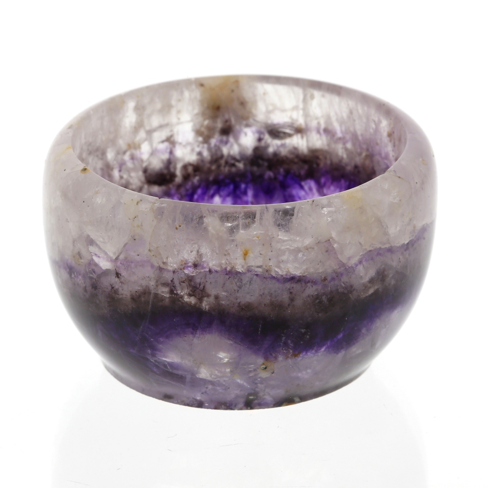 A small Blue John bowl. The hemispherical body with a medial band of violet veining beneath pale