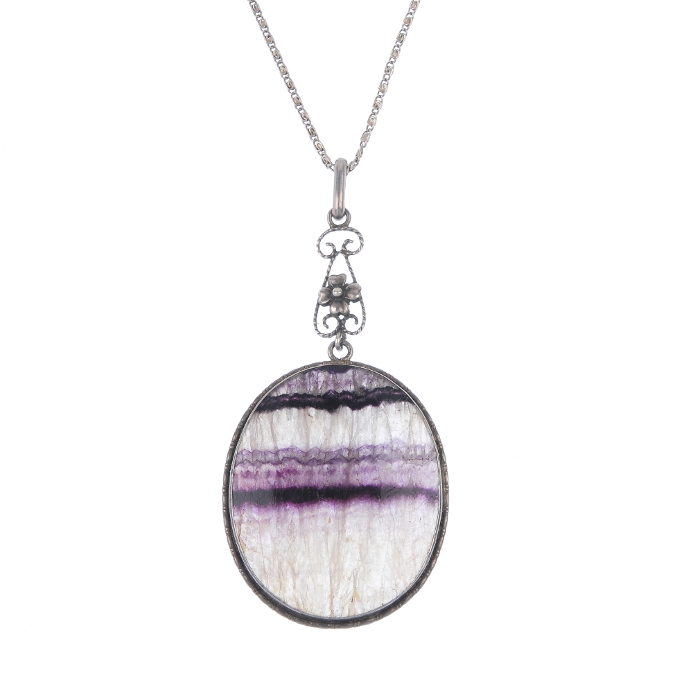 A Blue John pendant Of oval section with lilac and dark amethyst parallel veining, 29mm x 37mm, in