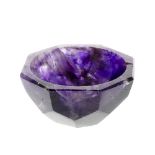 A small fluorite octagonal bowl Of mottled amethyst hue with hemispherical interior and