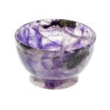 A small Blue John bowl. Of hemispherical form with flared foot, 54mm diameter x 33mm high, 74gms.