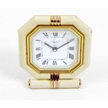 A Cartier desk clock. The octagonal white Roman dial marked CARTIER PARIS, within cushion-moulded