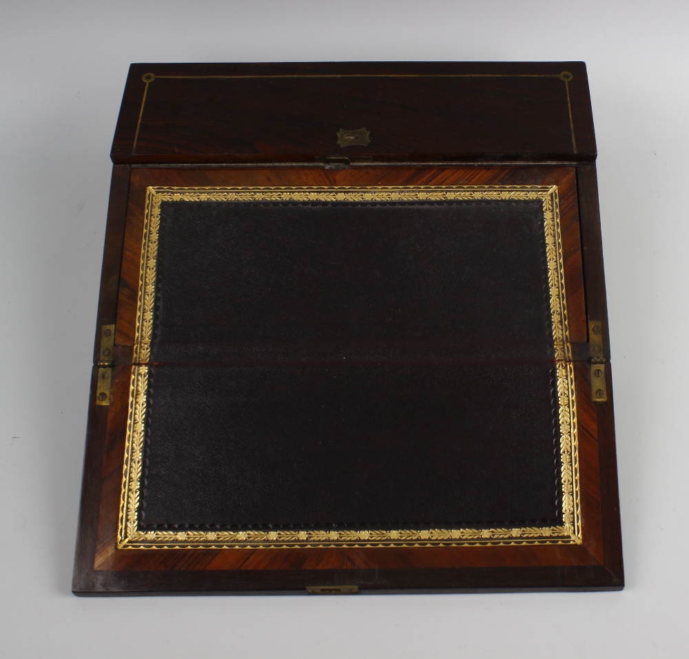 A Victorian rosewood lapdesk or writing slope with brass inlaid hinged cover, opening to reveal a - Image 2 of 2