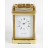 A Mappin & Webb brass cased reproduction carriage clock. The case with shaped carry handle and inset