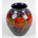 A Moorcroft vase. Of pear form having short neck, decorated with pomegranates and berries upon a