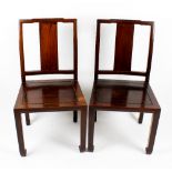 A set of four 20th century Chinese hardwood chairs, having shaped top rail and wide plain splat,