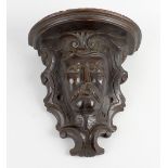 A 19th century carved wooden wall bracket. The shaped top with moulded edge above a support,