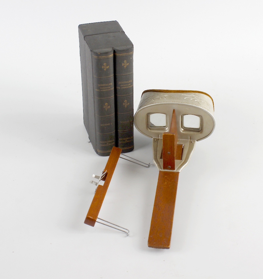 A stereoscope and assorted cards. Approximately 35 cards, various themes, in simulated two-volume