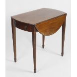 A mahogany oval drop-leaf side table. Having single frieze drawer with false drawer verso, raised