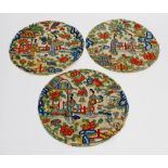 A selection of twelve Chinese embroidered silk panels. Each of circular outline and similar design