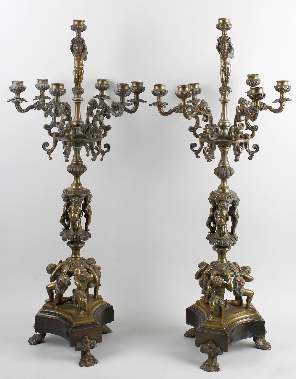 A pair of large Regency-style bronze candelabra. Each having six scrolling branches leading to the