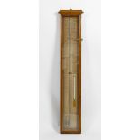 An oak cased wall hanging Admiral Fitzroy barometer. With mercury filled tube and alcahol filled