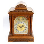 A good late 19th century oak-cased triple fusee bracket or table clock The 6.5-inch arched brass