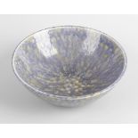 A Ruskin pottery bowl. The whole finished in a merging blue and yellow crystalline glaze,