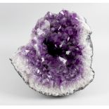 A large Amethyst geode 14.5 (37 cm) high. Together with two other similar smaller examples.