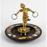 A 19th century lady's dressing table bijouterie or pen stand. The gilt metal figure of a cherub with