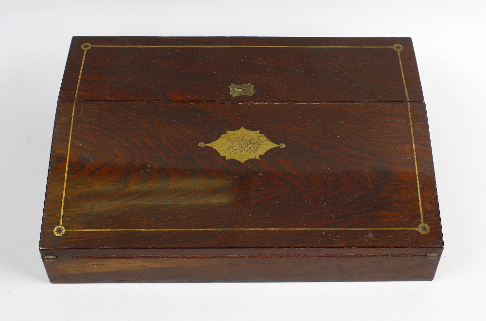 A Victorian rosewood lapdesk or writing slope with brass inlaid hinged cover, opening to reveal a