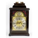 A mid 18th century ebonised bracket clock. The 7-inch two-piece break-arched dial having a