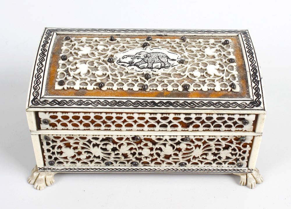 An Indian Vizagapatam miniature casket. The hinged cover having pieced plaque with central