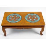 A Chinese cloisonne-inset hardwood low table. The rectangular top with two large circular panels, on