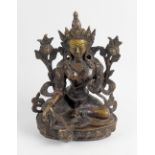 An unusual cast metal figure depicting the Tibetan goddess 'White Tara' in traditional seated pose