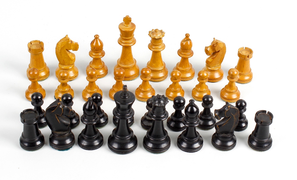 A 19th century boxwood chess set. Comprising black and natural pieces, each of turned form and